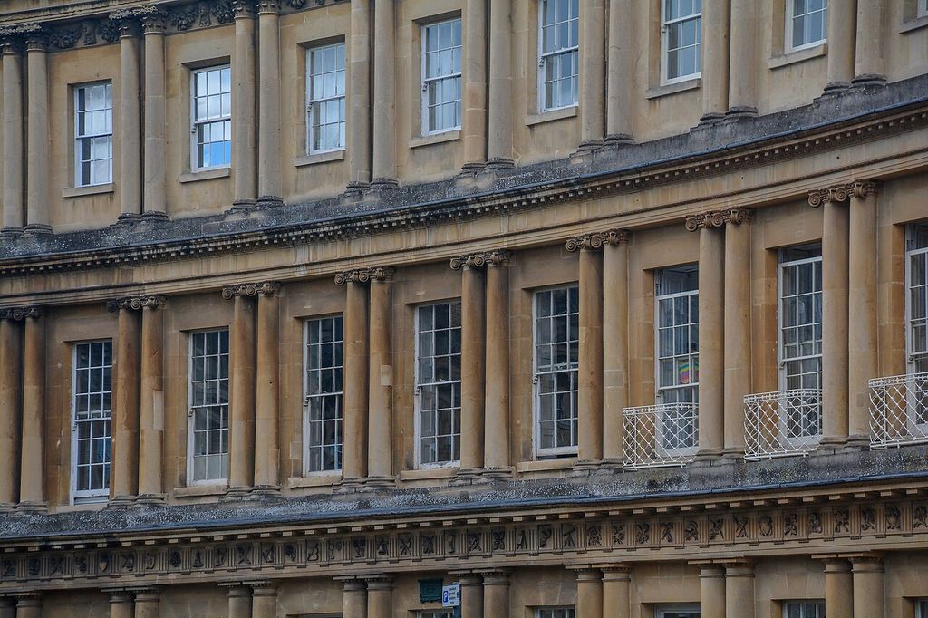Columns and entablatures divide the curved stone terrace into successive storeys and window bays.