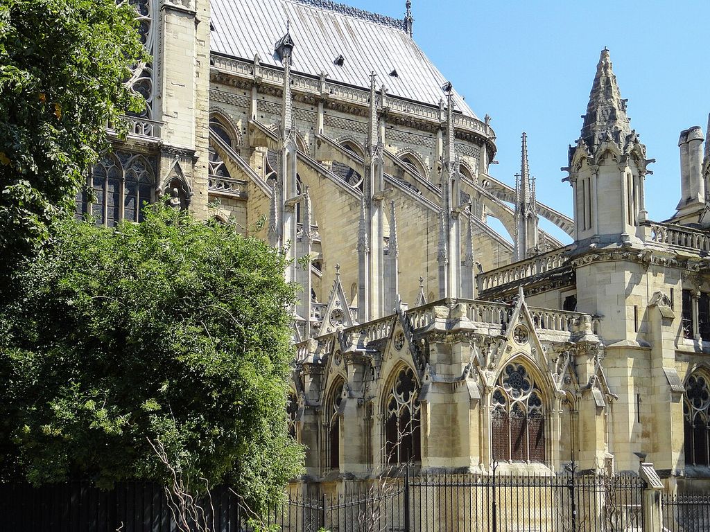 Flying buttresses of the Notre Dame de Paris, tying in with the Gothic Architecture and was one of the first buildings to have this kind of architectural support, showing gothic flying buttress.