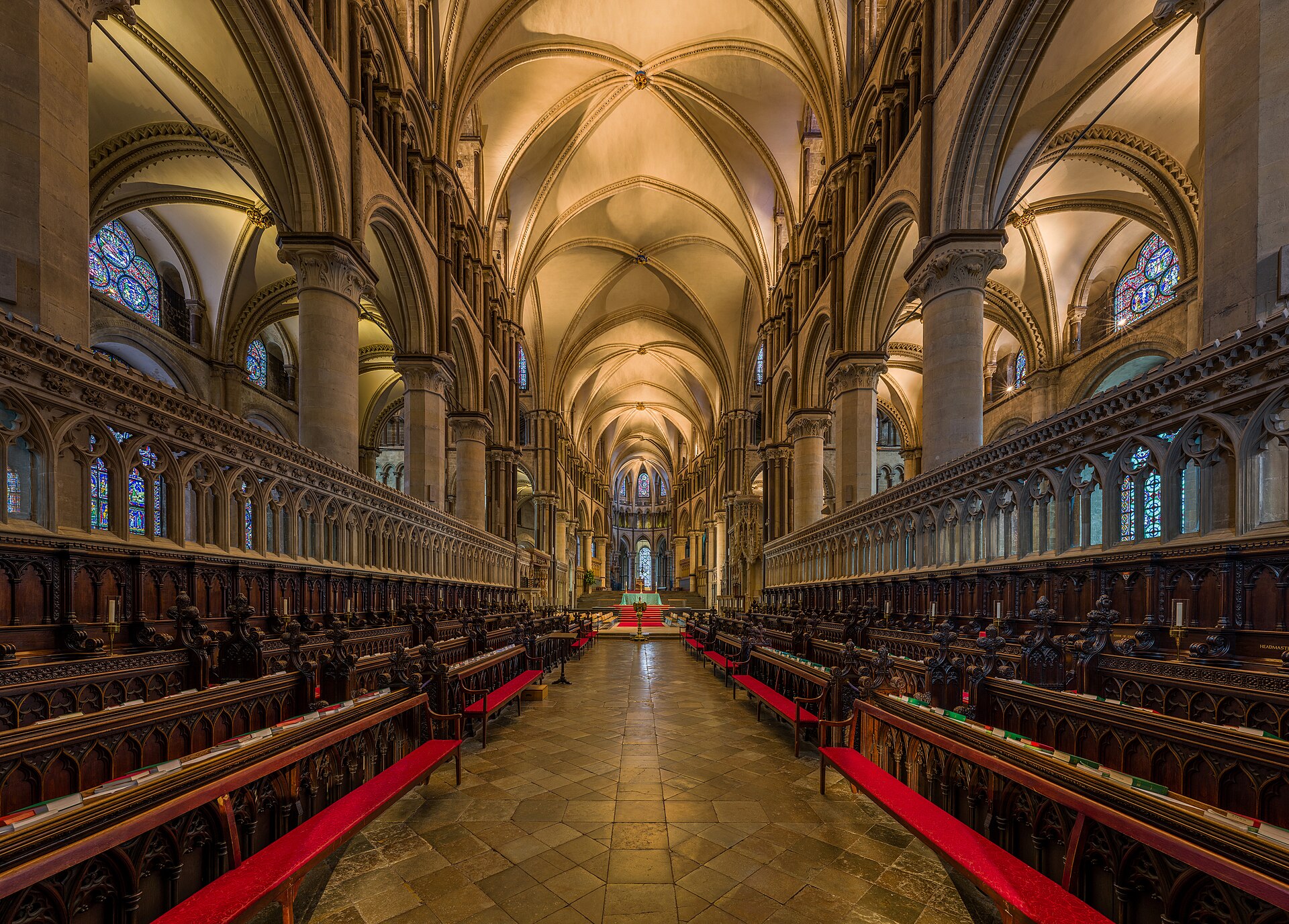 Canterbury Cathedral choir looking east through pointed arcades, dark polished shafts and rib vaults toward the high altar and Trinity Chapel.