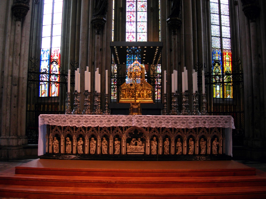 The dark high altar stands before the gold and silver Shrine of the Magi inside Cologne Cathedral’s choir.
