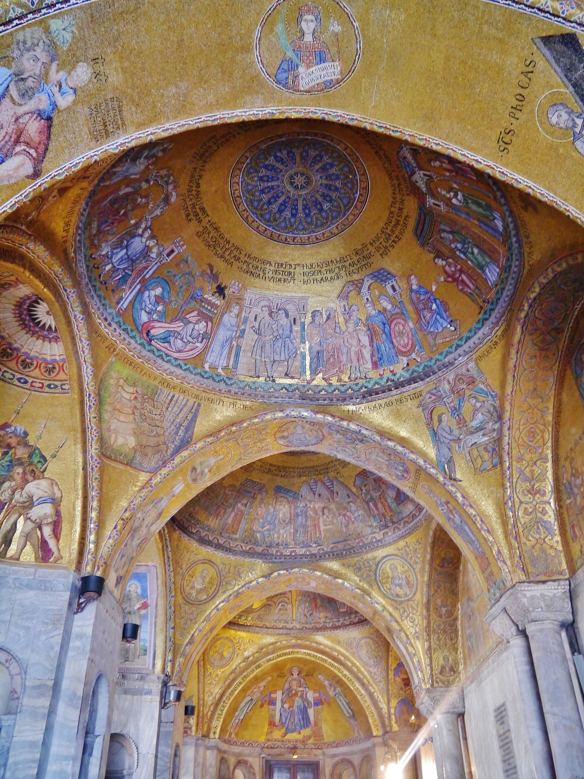 Gold mosaic domes and arches of the narthex at St Mark’s Basilica, seen in receding sequence.