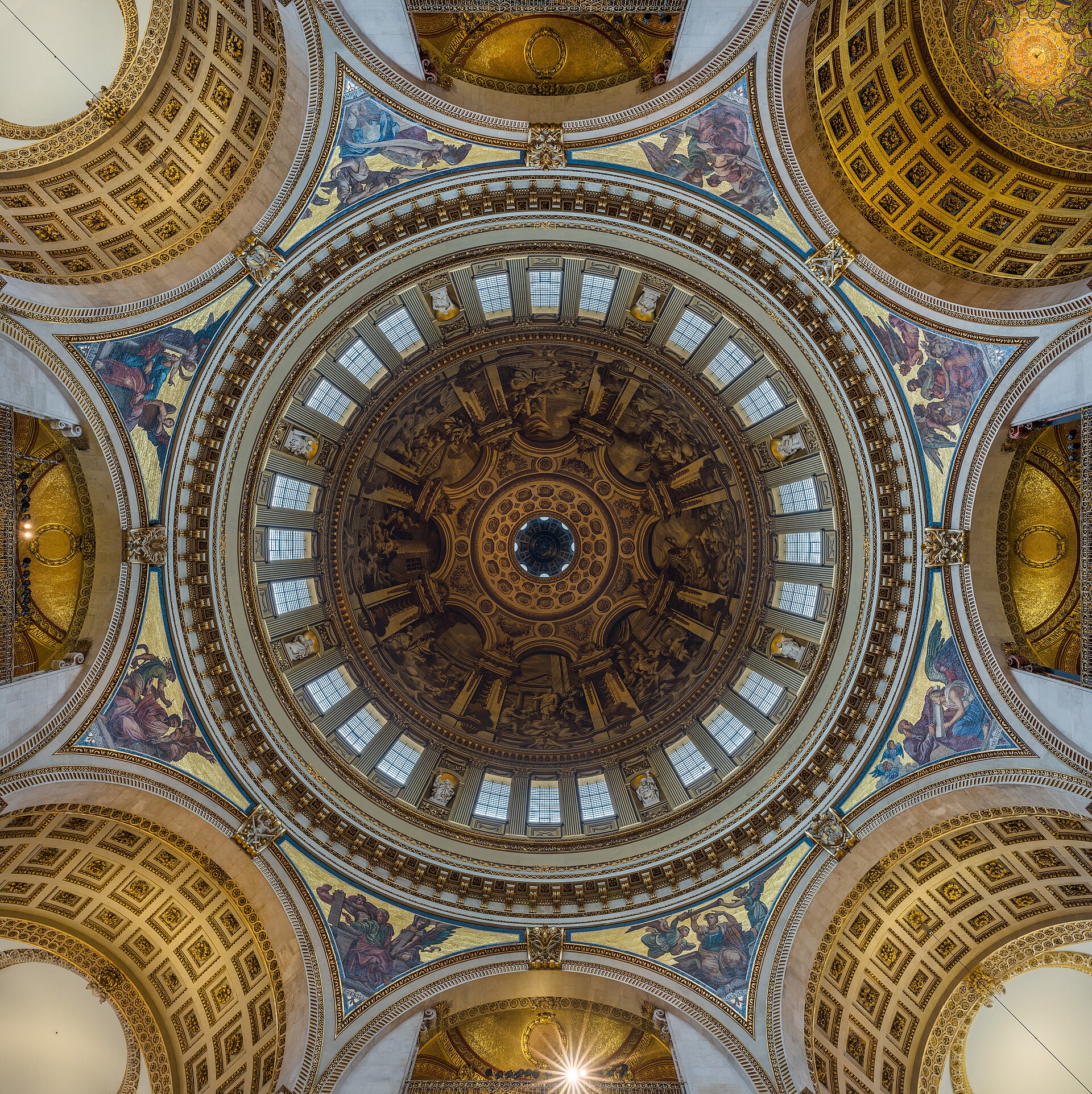 Upward view into St Paul’s painted inner dome, surrounded by arches, pendentives, galleries and windows.