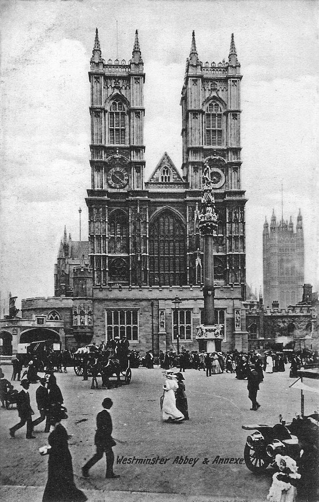 A grainy black-and-white street view shows Westminster Abbey's twin west towers above a temporary low Gothic entrance, crowds and horse-drawn vehicles.