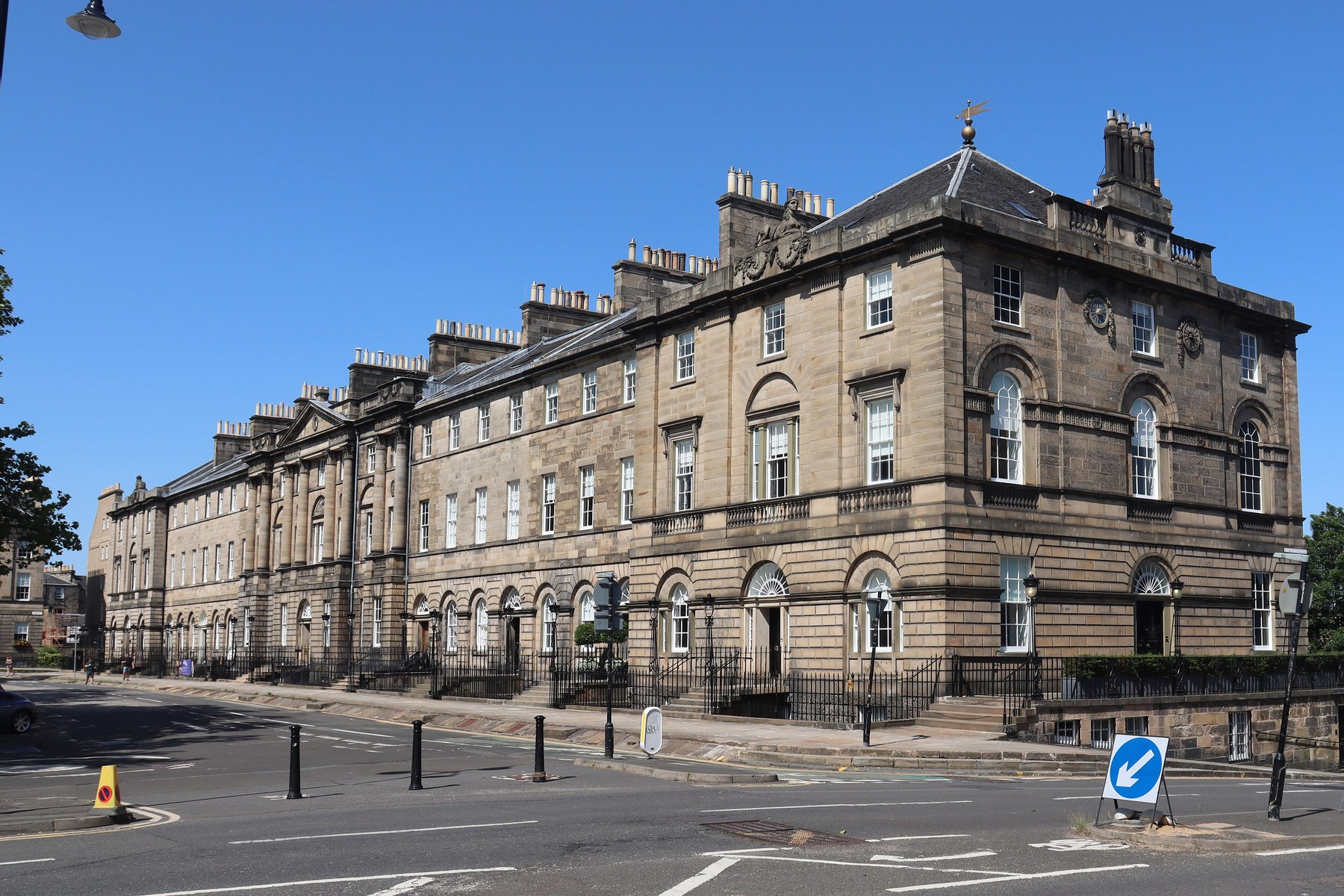North side of Charlotte Square, Edinburgh, with horizontal stone courses, rusticated lower levels and rows of windows.