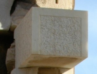Restored Erechtheion block with a recessed, roughly textured centre surrounded by smooth joint margins.