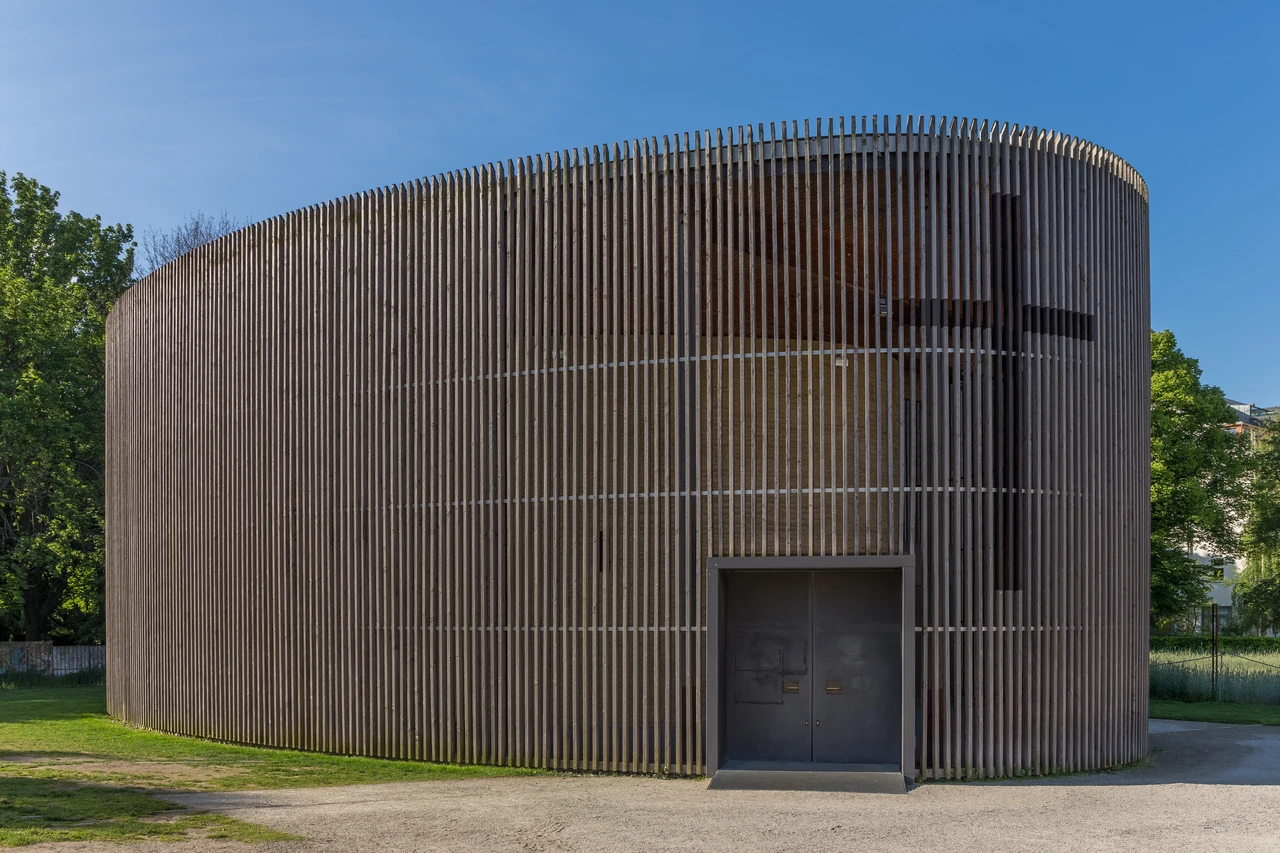 Berlin Chapel of Reconciliation's curved exterior screened by vertical timber louvres.