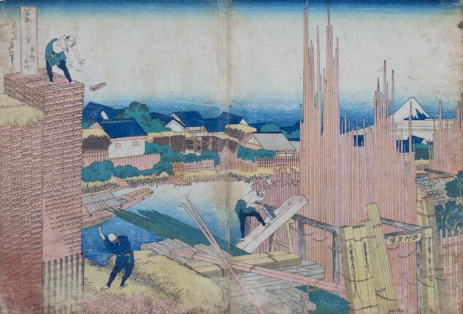 Hokusai print of stacked timber, standing boards and workers sawing and handling wood, with Mount Fuji beyond.