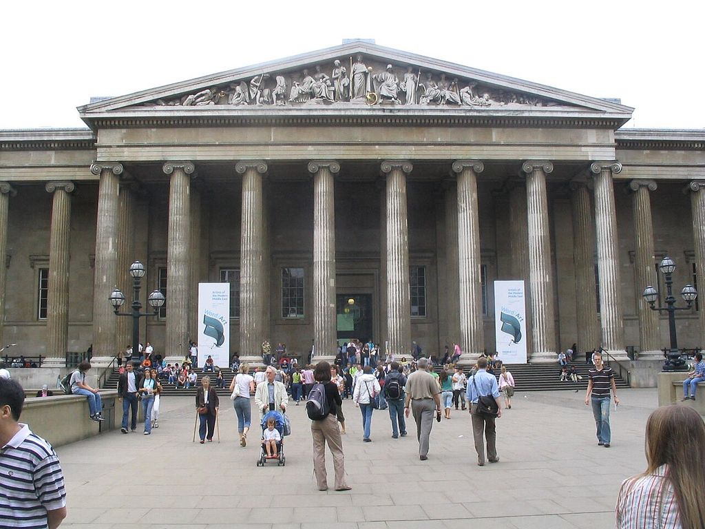 Ionic columns support a broad sculptured pediment above the museum entrance and visitors on the forecourt.