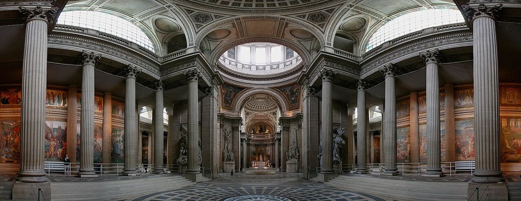 Freestanding Corinthian columns frame a domed crossing and vaults lit by high windows inside the Paris Panthéon.