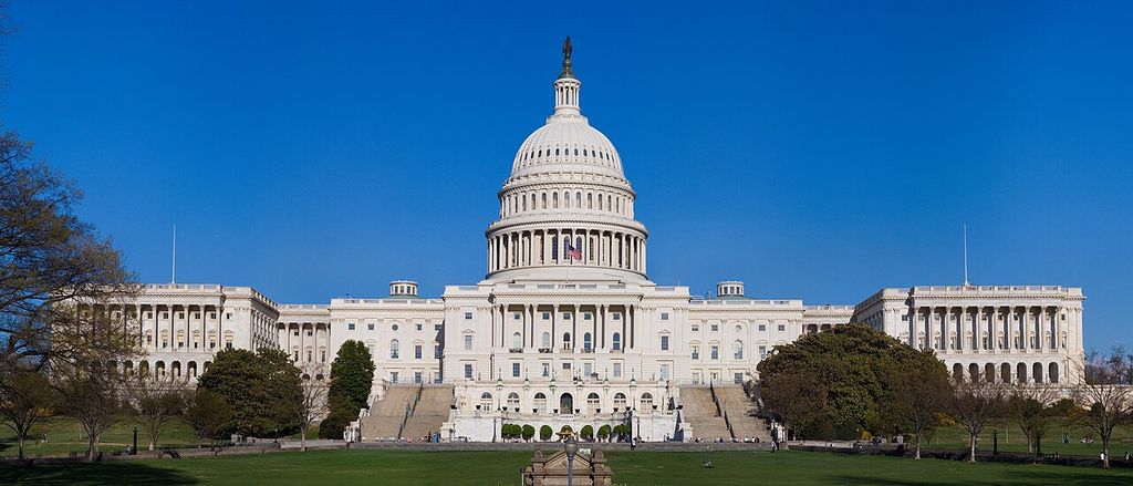 A central dome rises above a portico and broad symmetrical wings on the U.S. Capitol’s west front.