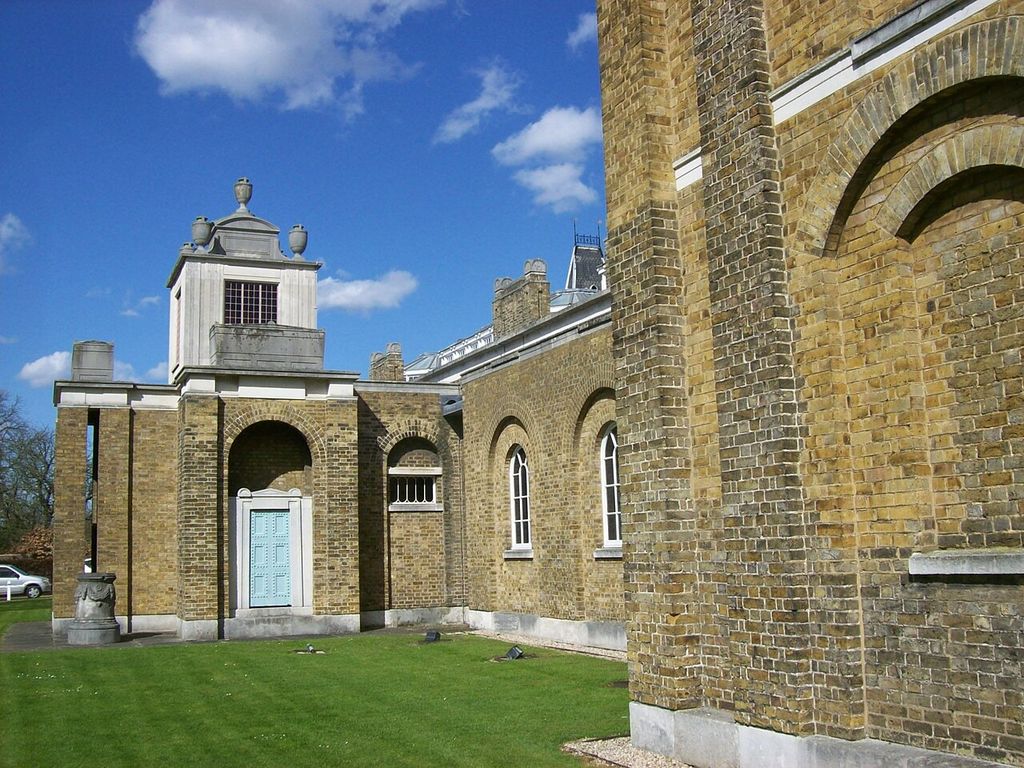 Brick walls with blind arches and selected stone dressings meet a raised roof element.