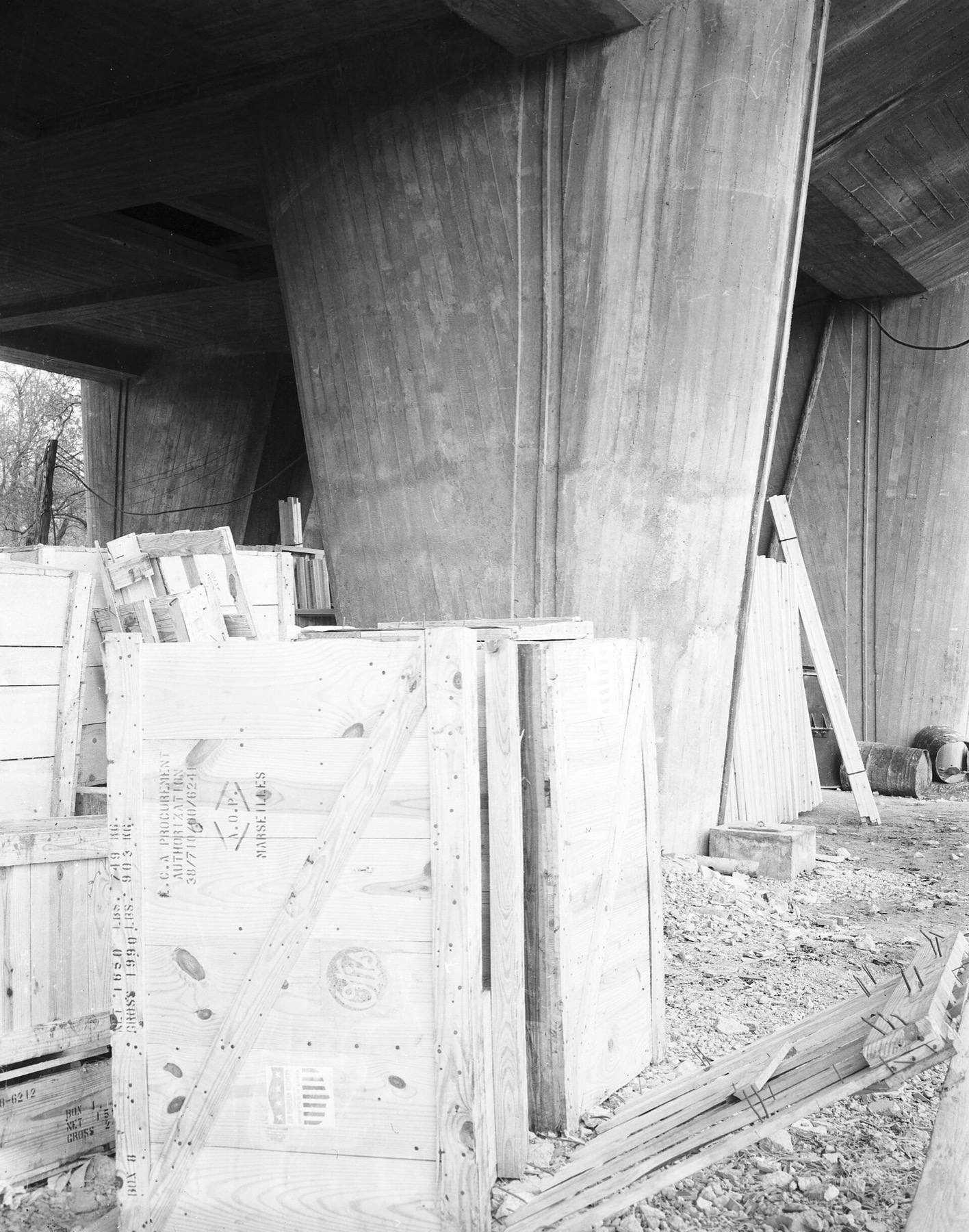 Historic construction photograph of board-marked concrete supports and timber formwork at the Marseille housing project.