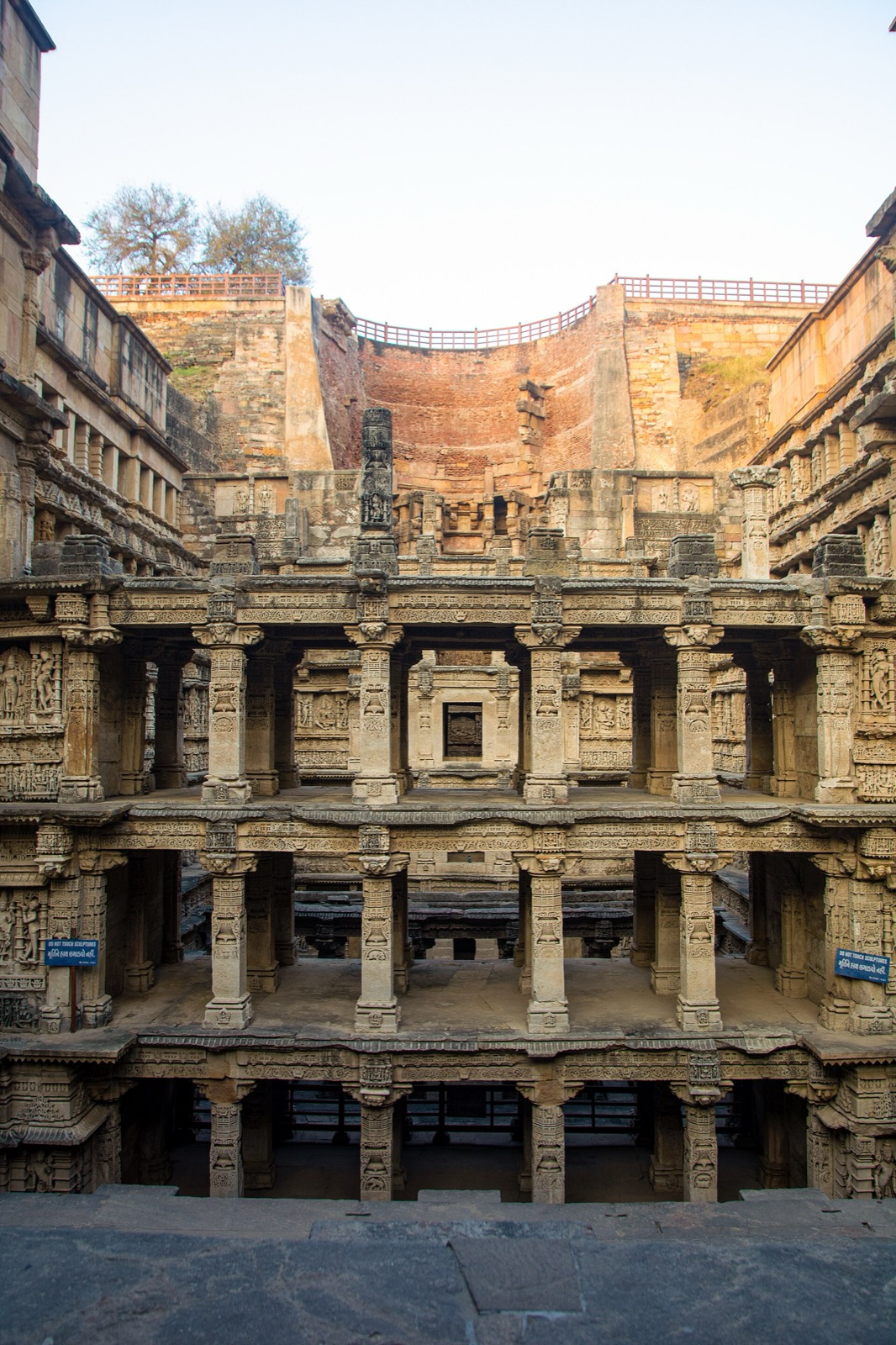 View through multiple carved pavilion levels of Rani-ki-Vav toward the well end.