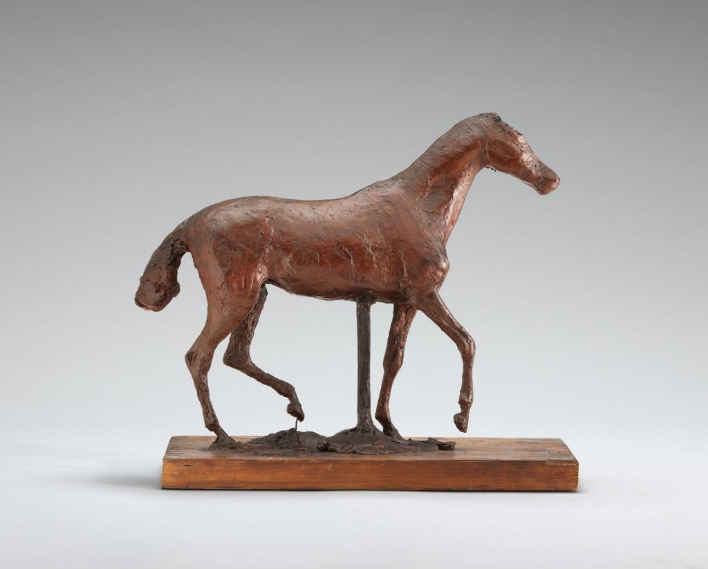 Original wax horse walking with one foreleg raised