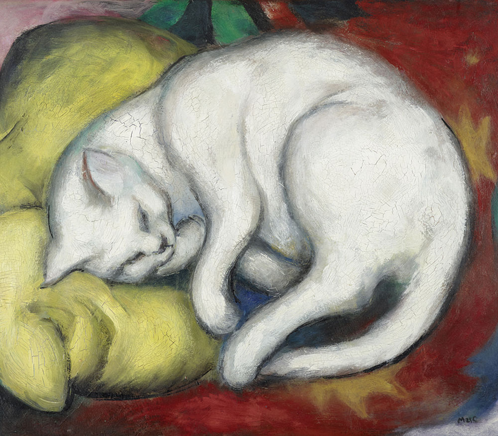 A white cat sleeps curled on yellow cushions in Franz Marc's Cat on a Yellow Pillow.