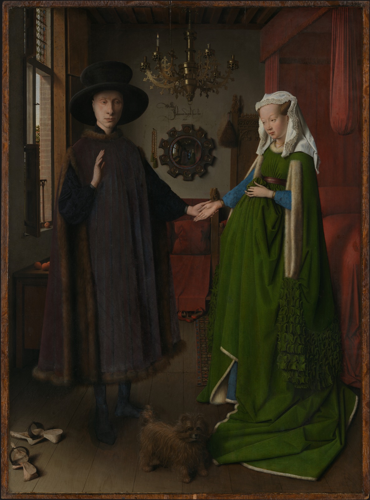 A man and woman stand in a furnished interior with a small dog and convex mirror