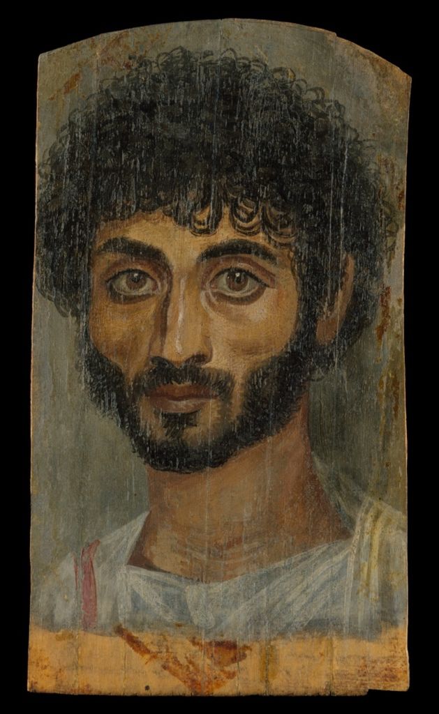 Roman-period encaustic portrait painted on a narrow limewood panel, showing paint and wooden support as one object.