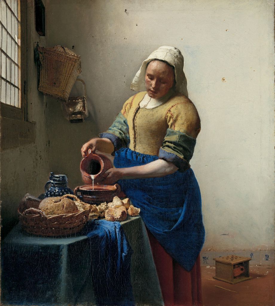 Vermeer's Milkmaid pours milk beside a table of bread and vessels against a pale wall.