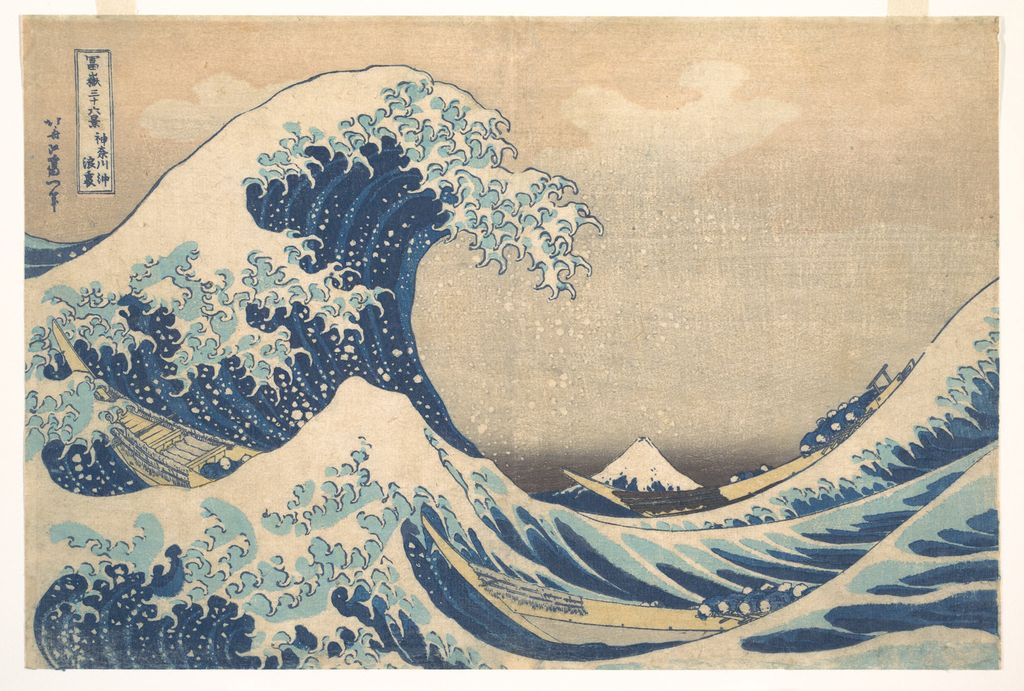 Hokusai's Great Wave curls over three boats with Mount Fuji small on the horizon.