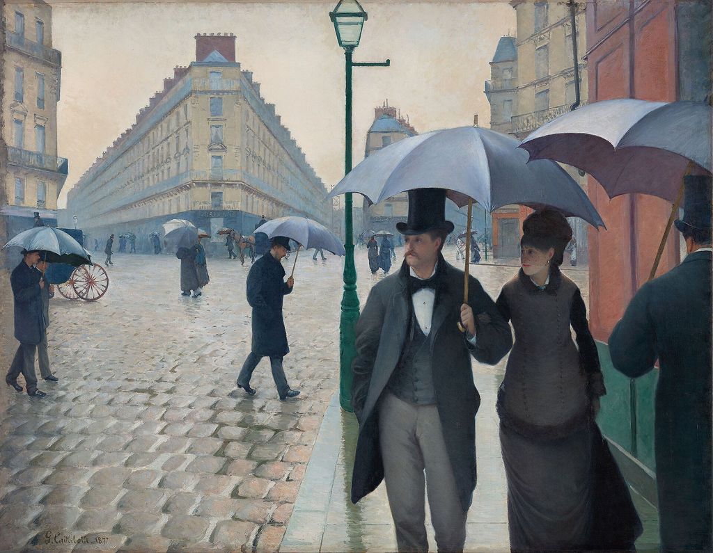 Caillebotte's rainy Paris street shows umbrella-carrying figures crossing broad wet paving between pale city buildings.