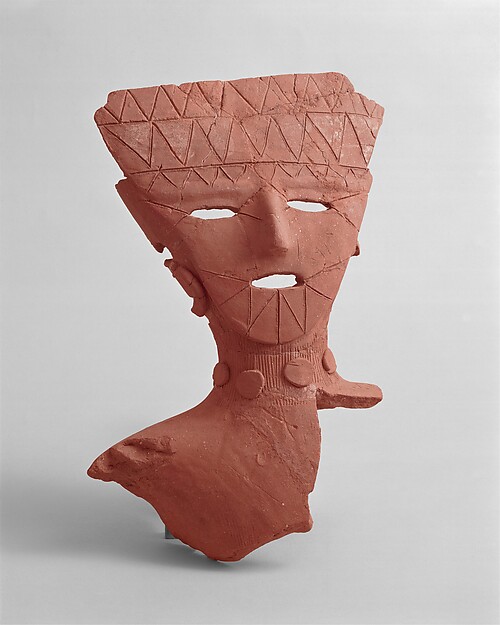 Haniwa earthenware head with open eyes and mouth, painted traces, incision and applied details.