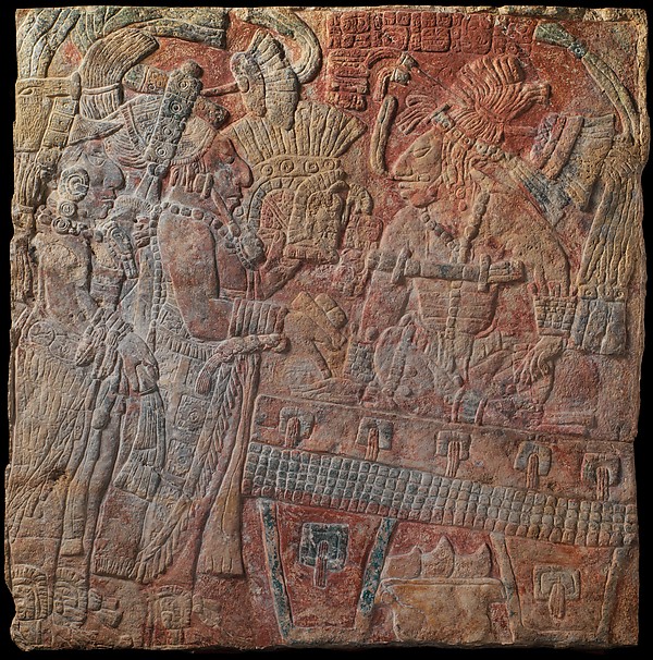 Very shallow Maya limestone relief showing an enthroned ruler with figures and inscriptions.