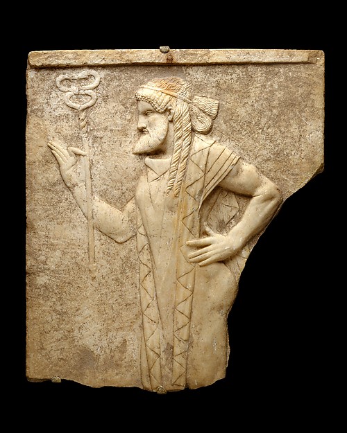 Roman marble relief of Hermes in an archaistic pose with elaborate curls and stiff drapery.