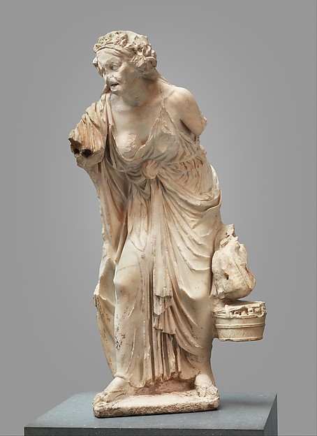 Roman marble statue of an elderly woman carrying a basket, with deeply carved drapery.